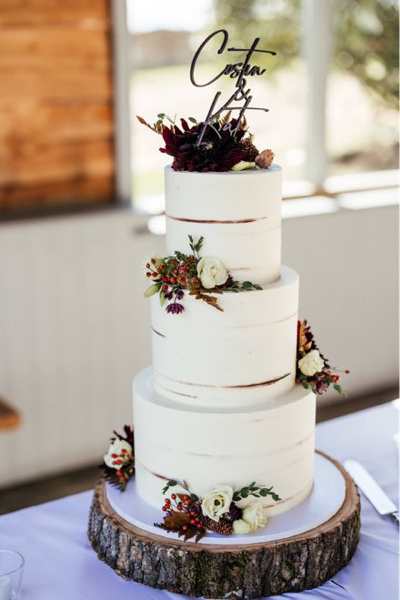 Buttercream iced three tiered wedding cake at Stone Barn - image by Kirsty Mackenzie
