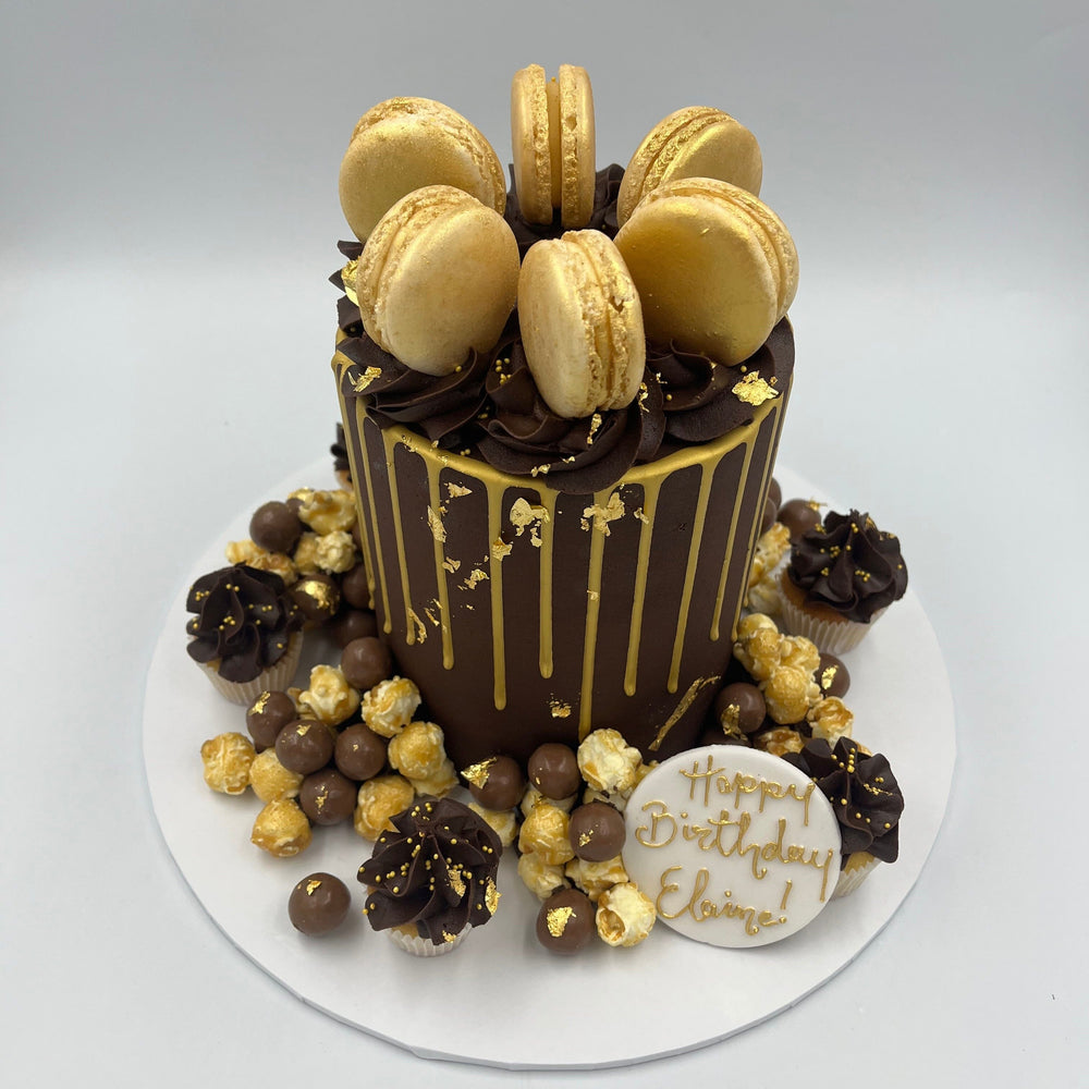 Gold and chocolate drip cake with popcorn and malteasers at Vanilla Pod Bakery