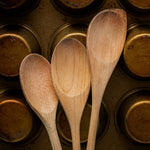 wooden mixing spoons and cupcake baking tins